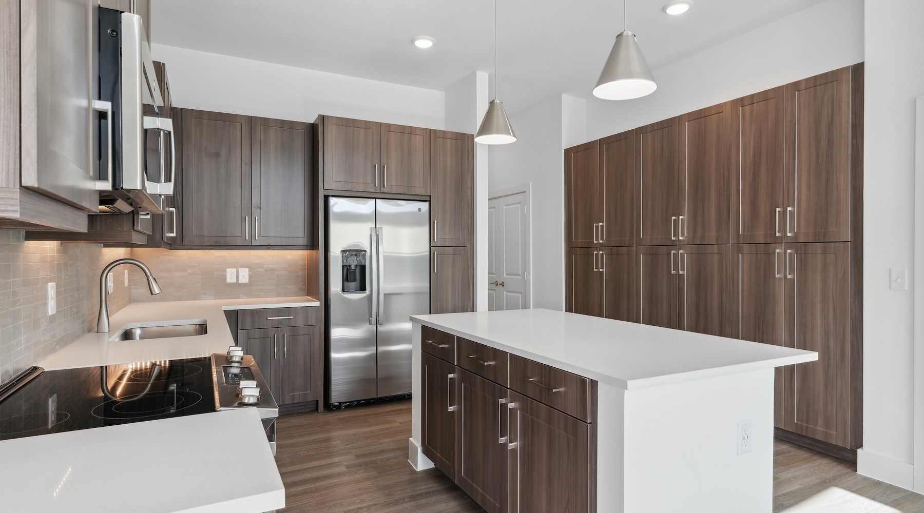 a kitchen with dark wood cabinets