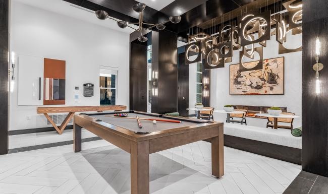 a clubroom with a pool table and chairs
