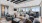 a clubroom with a a couch, chairs and tables
